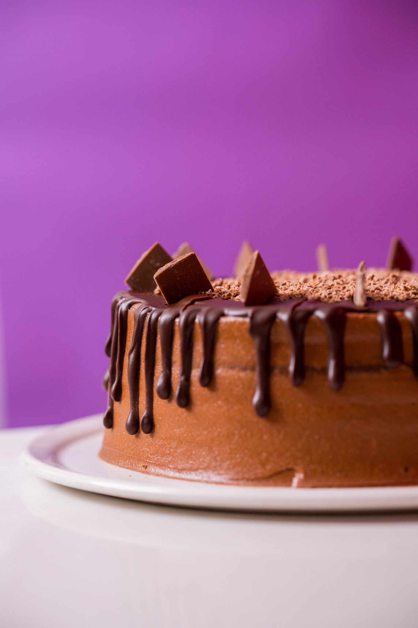 A chocolate celebration cake with glossy chocolate drip icing
