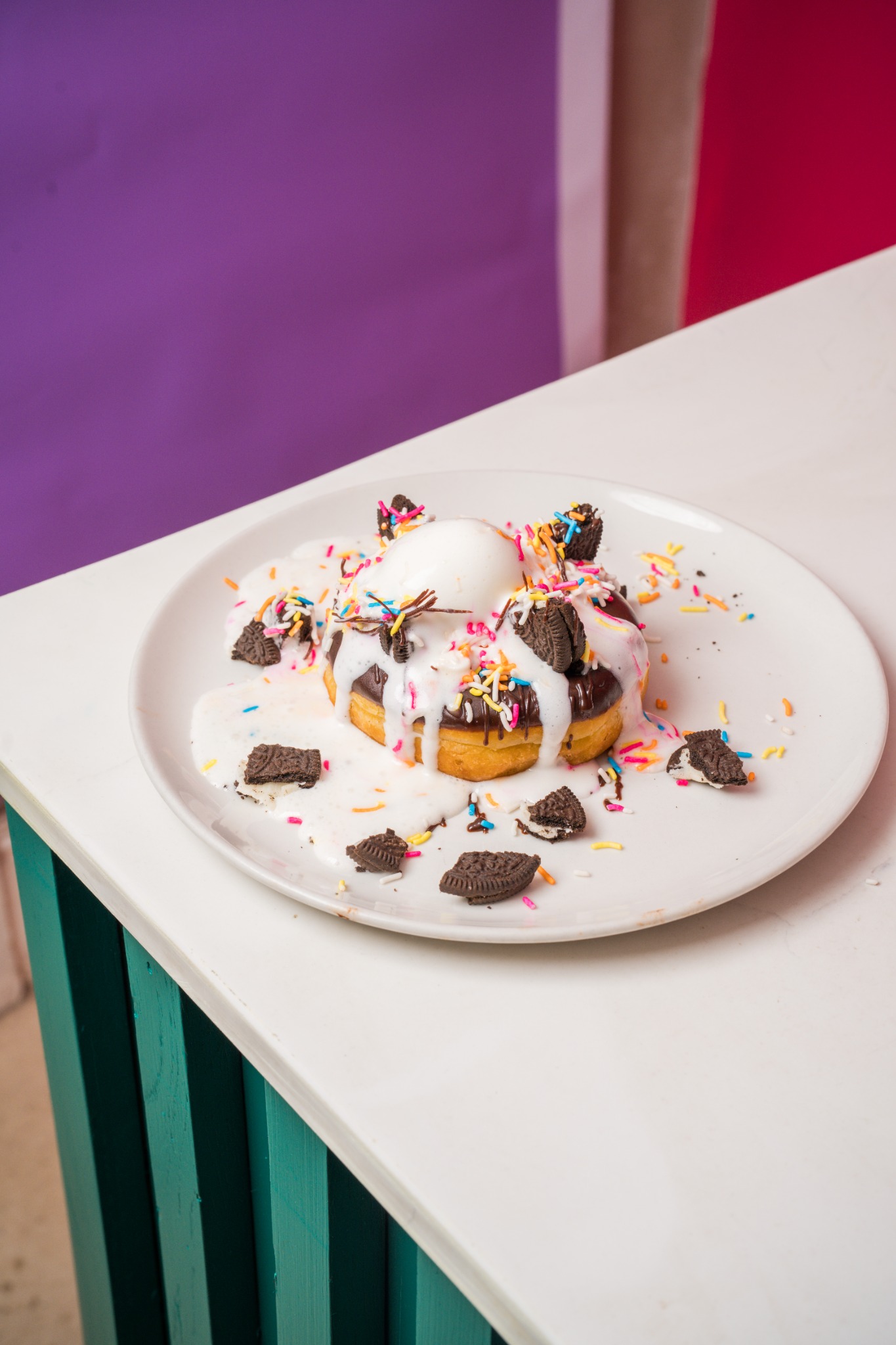A dessert plate topped with ice cream, cookies and sprinkles
