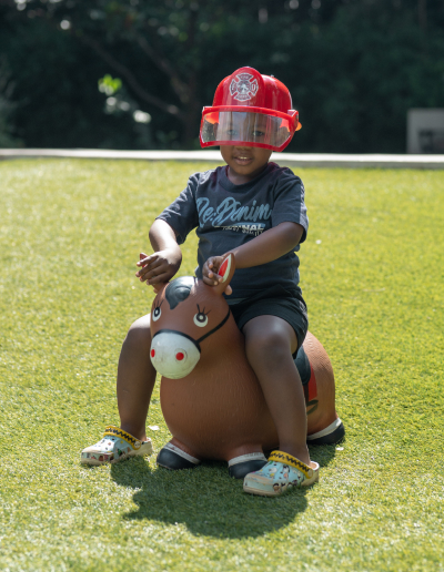 A child playing outdoors on the JoyJozi lawn